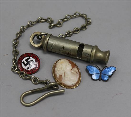 A Nazi badge, a silver enamel butterfly, a compass and a police whistle, etc